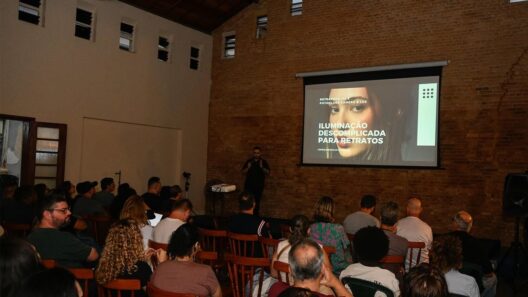 Público assiste à palestra Iluminação Descomplicada para Retratos em um auditório com paredes de tijolos